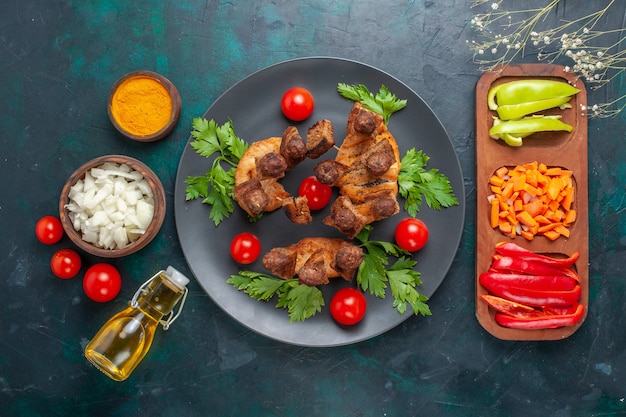 Top view sliced cooked meat with greens cherry tomatoes and olive oil on blue background