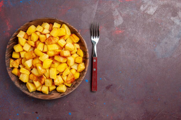 Top view sliced cooked potatoes inside plate on the dark