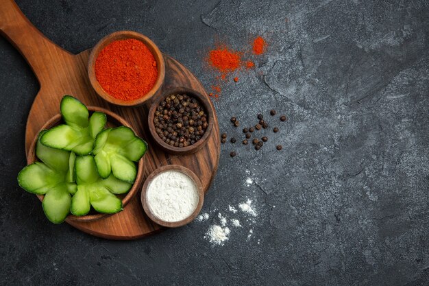 Top view sliced cucumbers with seasonings on grey background salad health vegetables meal food