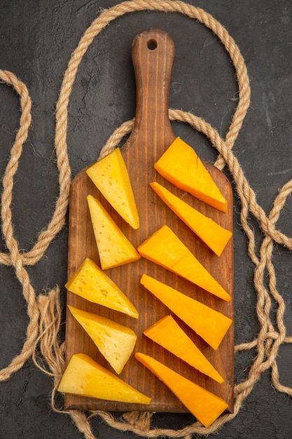 Top view sliced fresh cheese on dark background