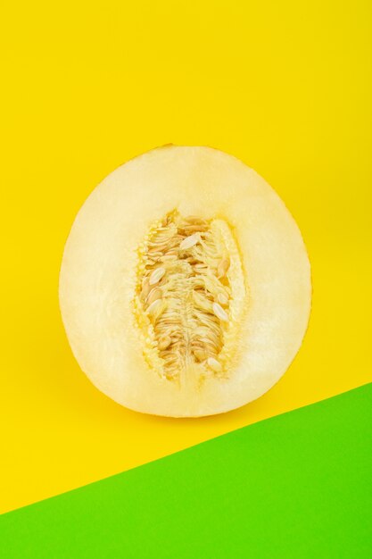 A top view sliced fresh melon sweet pulpy mellow isolated on green-yellow