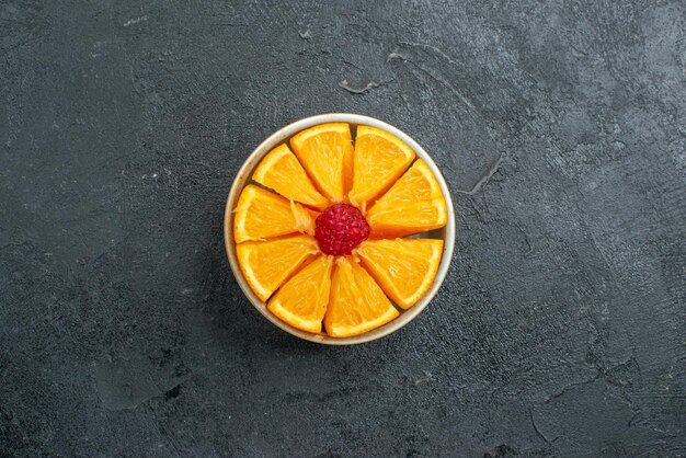 Top view sliced fresh oranges inside plate on dark surface citrus exotic fruit