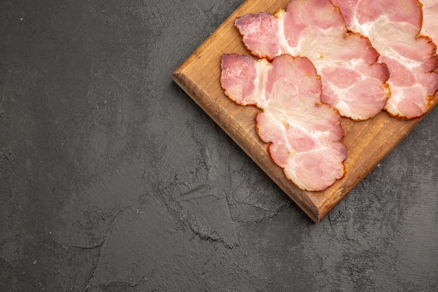 Top view sliced ham on wooden desk and a grey background