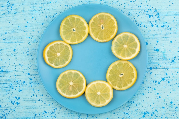 top view sliced lemon sour juicy mellow inside blue plate on the bright blue floor