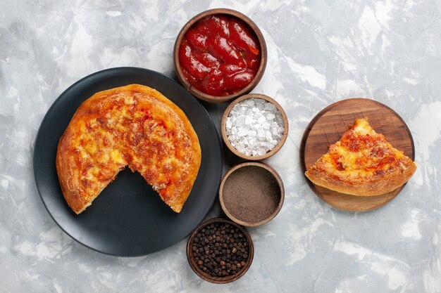 Top view sliced pie with seasonings on white