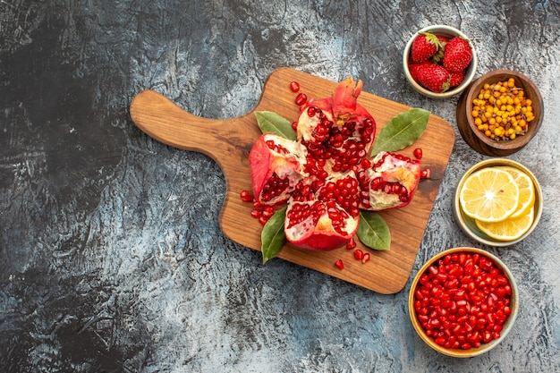 Top view of sliced pomegranates with various ingredients