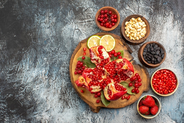 Top view of sliced pomegranates with various ingredients