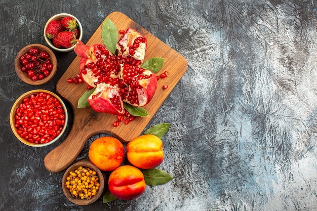 Top view of sliced pomegranates with various ingredients