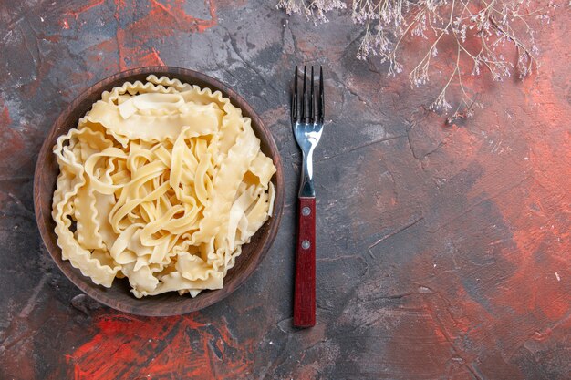 Top view sliced raw dough inside plate on dark surface dark dough pasta food raw