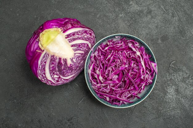 Top view of sliced red cabbage on dark background diet health ripe salad