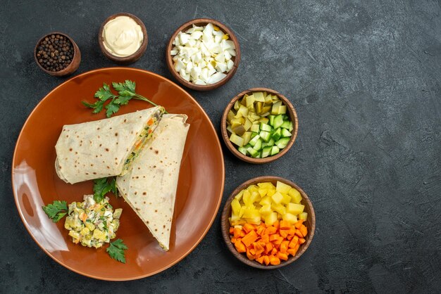 Top view sliced shaurma tasty meat and salad sandwich on grey surface burger sandwich bread pita meat salad