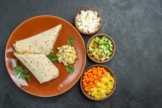 Top view sliced shaurma tasty salad sandwich on grey surface burger pita sandwich bread salad