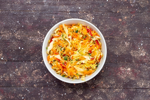 Top view sliced vegetable salad fresh and salted inside plate on the brown background vegetable food meal dish fresh photo