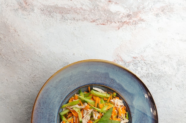 Top view sliced vegetable salad inside plate on the white background