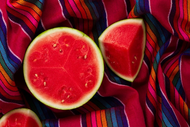 Free photo top view sliced watermelon on fabric