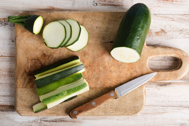 Top view sliced zucchini and a little knife