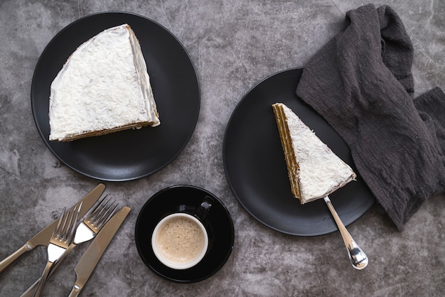 Top view slices of cake with coffee on the table