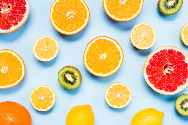 Top view of slices of citrus fruits, kiwis