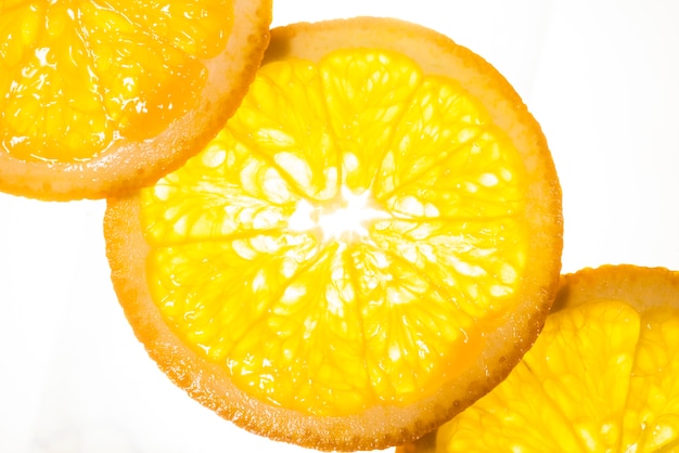 Top view slices of orange on white background