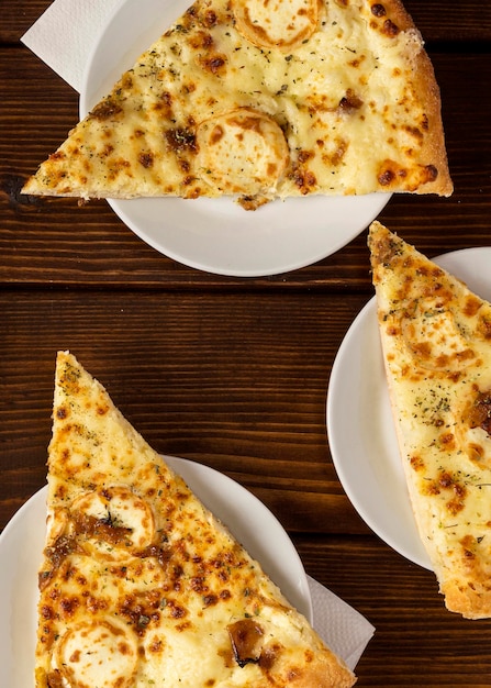 Top view slices of pizza with cheese on plate