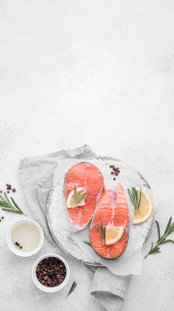 Top view slices of salmon with lemon copy space