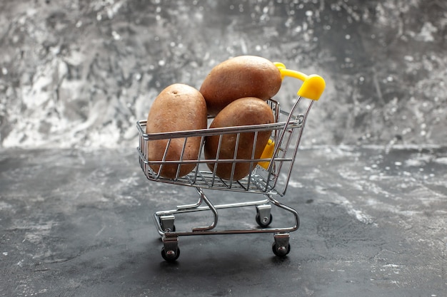 Top view of small folding shopping chart with potatoes in it