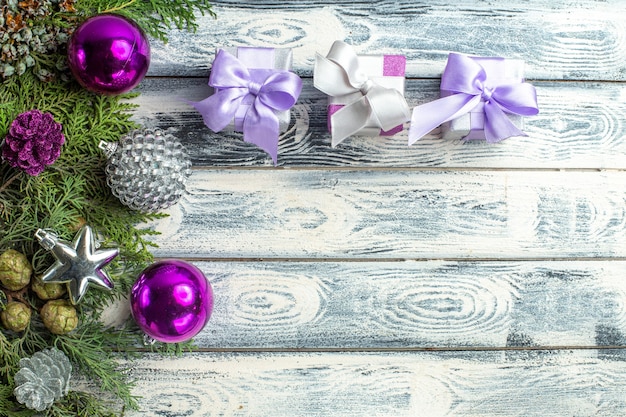 Christmas background. White Christmas fir tree with purple Christmas  decorations on a purple background Stock Photo