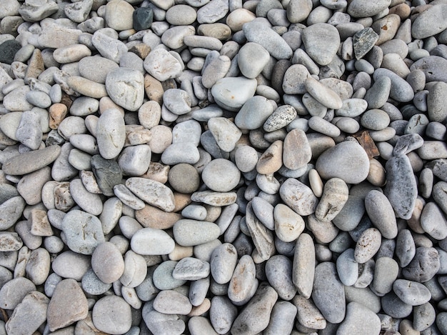 Top view of small pebble stones on the beach at daytime