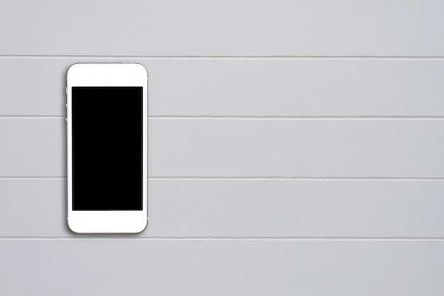 Top view smartphone mock up template with black screen on cement table with copyspace.