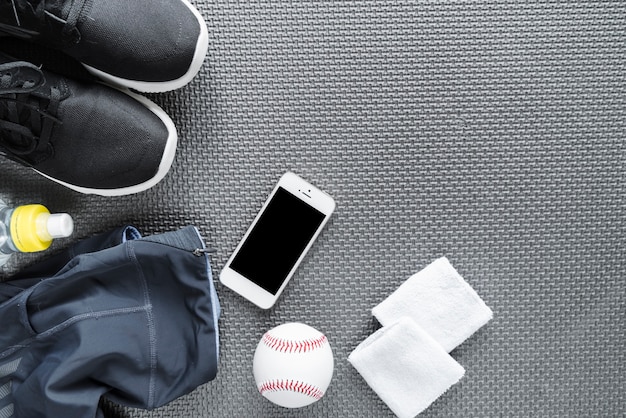 Top view of smartphone surrounded with sportswear