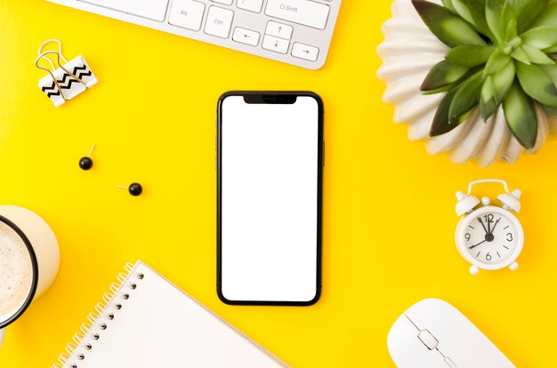 Top view smartphone template over workspace
