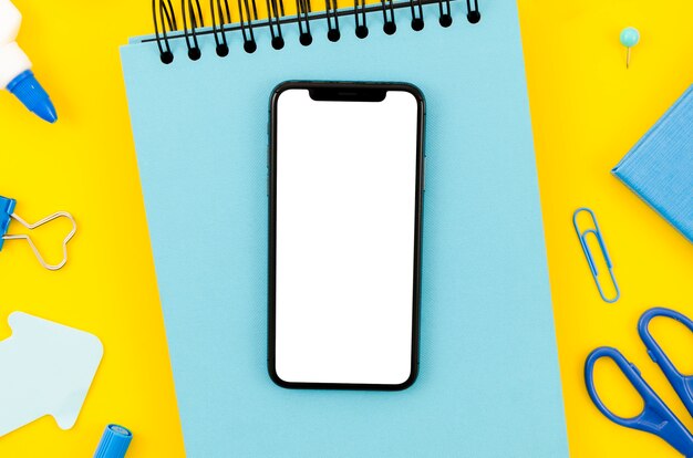 Top view smartphone template over workspace