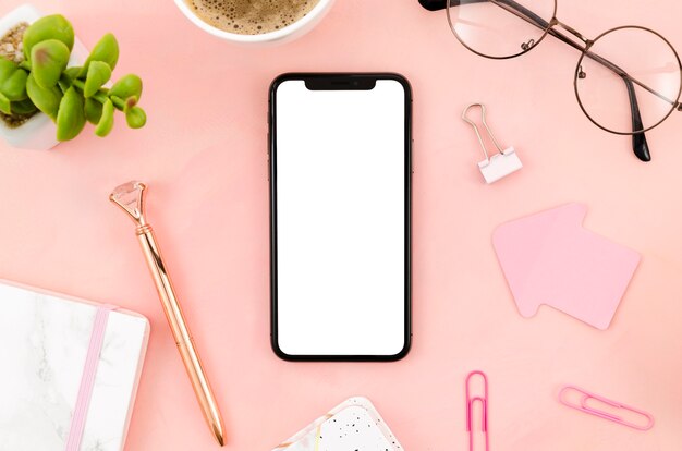 Top view smartphone template over workspace