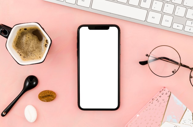 Free photo top view smartphone template over workspace