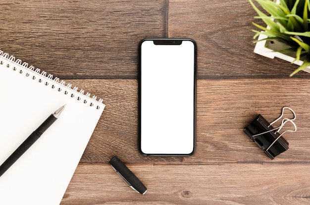 Top view smartphone template over workspace