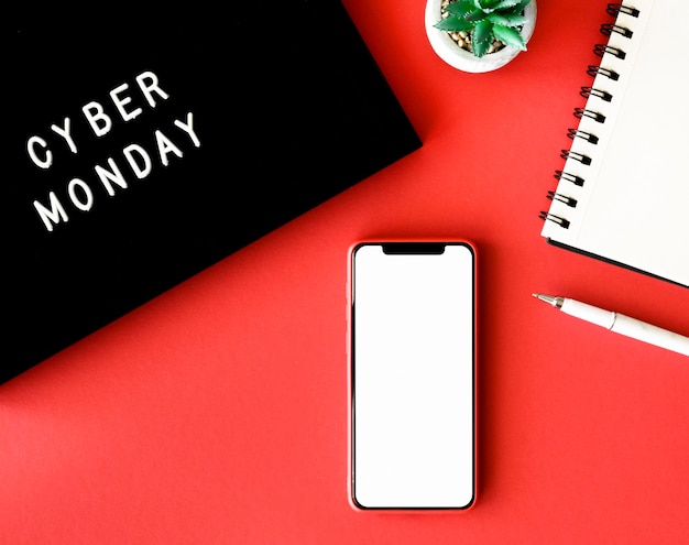 Top view of smartphone with plant and notebook for cyber monday