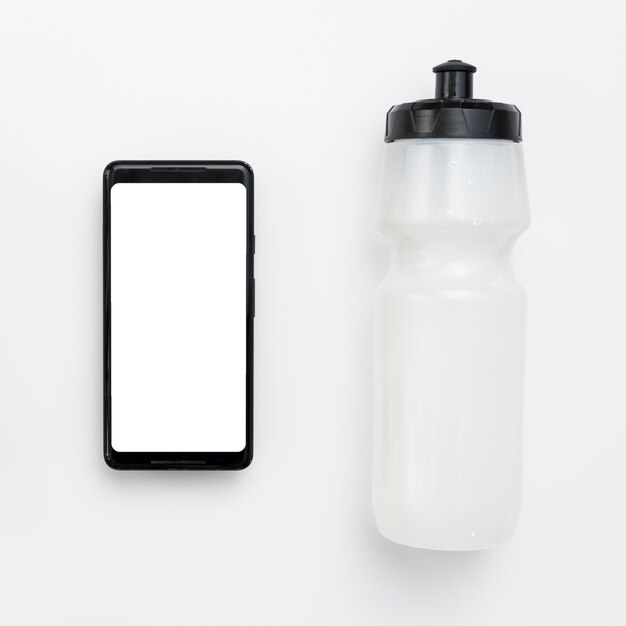 Top view of smartphone with water bottle