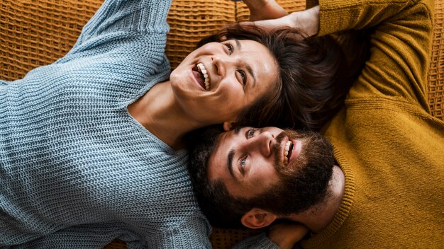 Top view smiley couple laying together