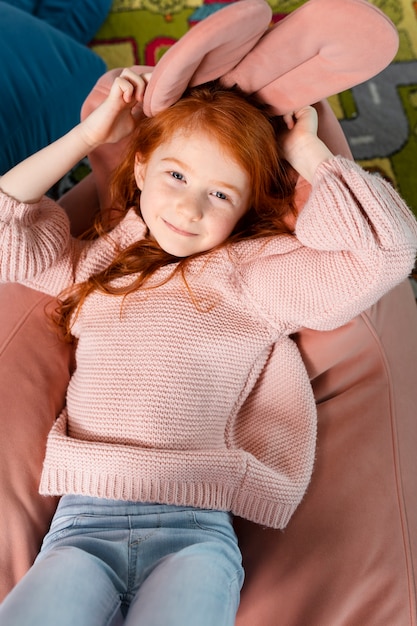 Top view smiley girl laying on floor