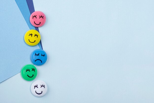 Top view of smiley and sad faces for blue monday with copy space