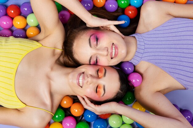 Top view smiley women laying together