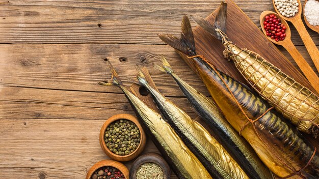 Top view smoked fishes on wooden table