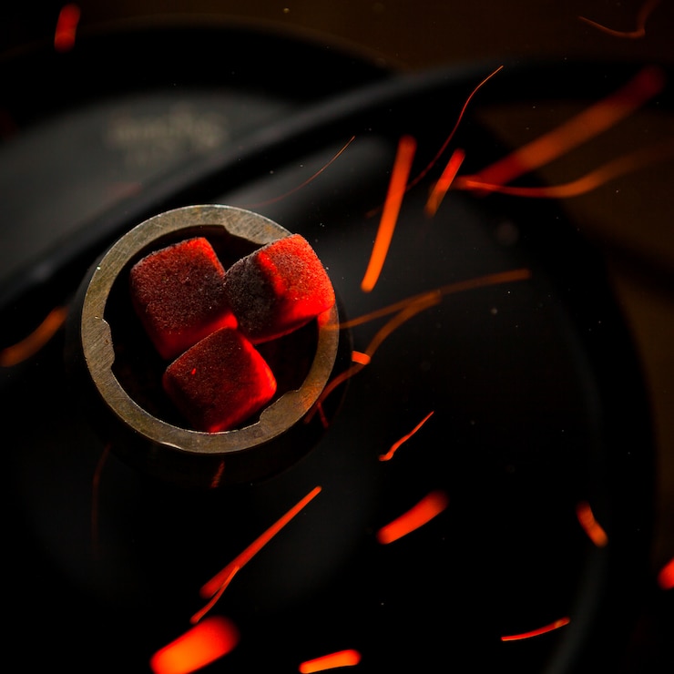 Free Photo top view smoldering coals with fire drops in steel flask