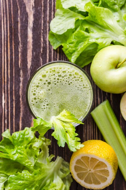 Top view smoothie glass with apple and salad