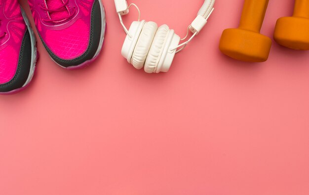 Top view of sneakers with headphones and weights