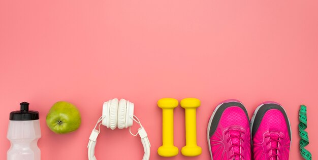 Top view of sneakers with weights and headphones