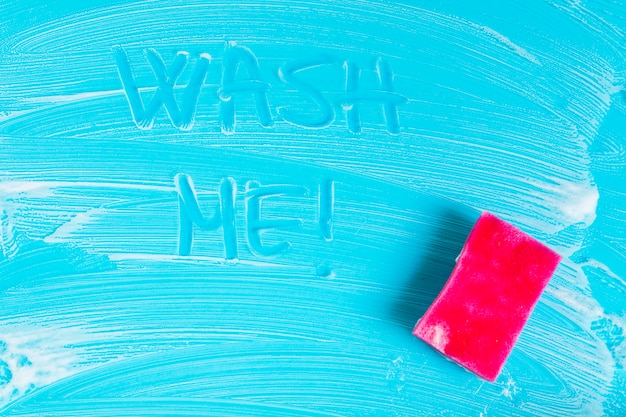 Top view soap foam and sponge on blue background