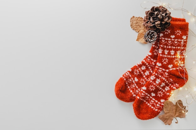 Free photo top view socks and pine cone with copy-space
