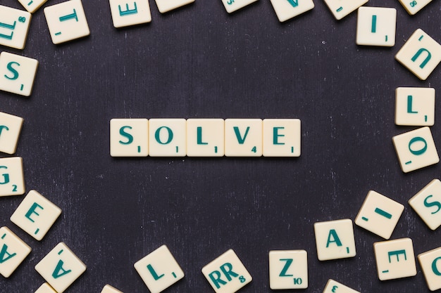 Free photo top view of solve text made from scrabble game letters