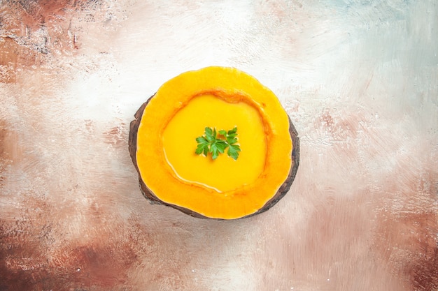 Free photo top view a soup an appetizing soup in the pumpkin on the board